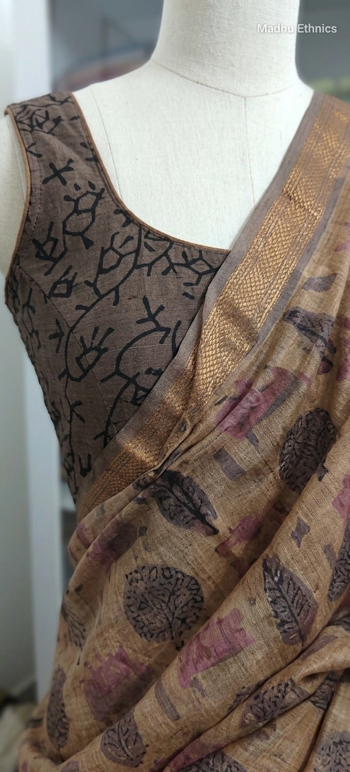 Saree with intricate patterns on a mannequin against a neutral background